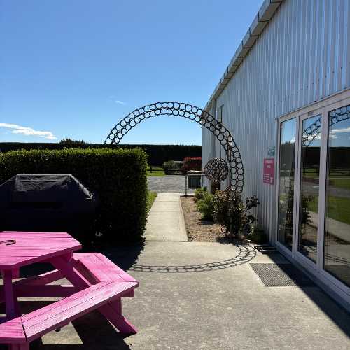 Outdoor picnic space in front of the conference room, private setting with a view of the arenas.