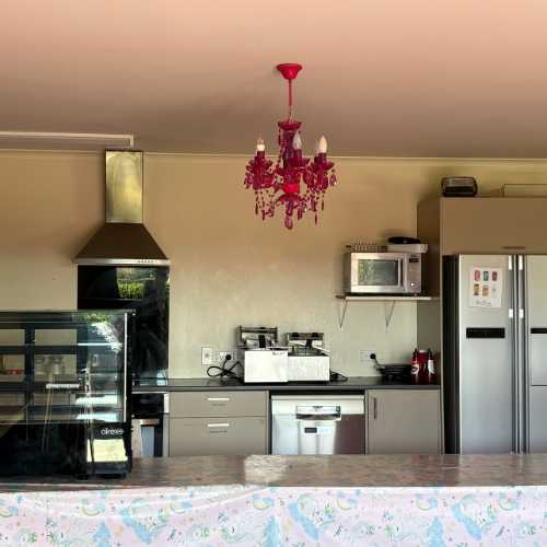 Fully stocked modern kitchen, stainless steel appliances, coffee machine and a refrigerator.  